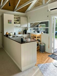 a kitchen with a sink and a counter top at Kalmar House On Fejø Near The Beach in Vesterby