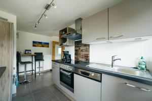 a kitchen with a sink and a stove top oven at Maso Fallmerayer - Fallmerayerhof in Albes +32 photos