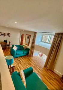 a living room with a blue couch and a table at Stunning spacious Apartment on River Ness in Inverness