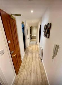 a hallway with a wooden floor and a door at Stunning spacious Apartment on River Ness in Inverness