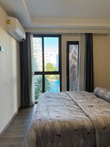 a bedroom with a large bed and a large window at The One Chiang Mai 420 - Deluxe 1BDR Pool View near Central Festival in Chiang Mai +77 photos