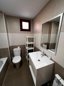 a bathroom with a sink and a toilet and a mirror at Nido de Sabi in Pardinilla +12 photos