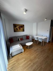 a living room with a couch and a table at Nido de Sabi in Pardinilla +12 photos