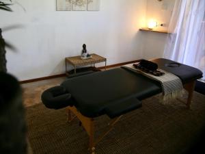 a room with a bed and a table and a chair at Turtle Cove Self-Catering Lodge & Yoga Shala in Praia do Tofo +5 photos