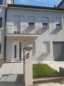 a white building with a fence in front of it at Casa Patavina in Padova