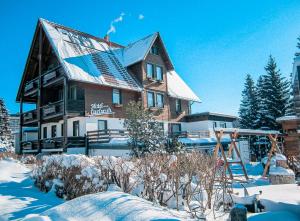 a large house with snow on the ground at Hotel Carlsruh in Braunlage