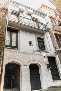 a building with a balcony on top of it at AP Apartment B&B in Bagnoli Irpino