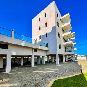a large white building with a balcony on the side at Zuri's Tidehouse, With Beach Access in Mombasa +34 photos