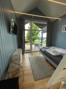 a bedroom with a bed and a view of a patio at Amma Jóna cottage in Hvolsvöllur
