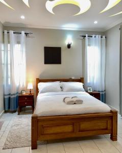 a bedroom with a large bed with a tv on the ceiling at Zuri's Tidehouse, With Beach Access in Mombasa
