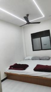 a bedroom with a bed with a ceiling fan at SHRI VIJAYVEER PALACE in Ujjain