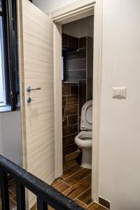 a bathroom with a toilet through a door at AP Apartment B&B in Bagnoli Irpino +52 photos