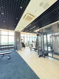 a gym with treadmills and machines in a building at Deluxe Kass Studio in Accra