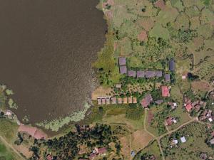 an overhead view of a house next to the water at Lake Chahafi Resort in Kisoro +3 photos