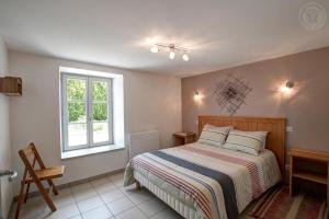 a bedroom with a bed and a window at Aux 3 provinces in Usson-en-Forez