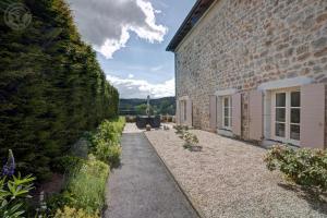 a walkway next to a brick building at Aux 3 provinces in Usson-en-Forez