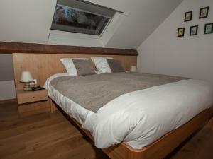 um quarto com uma cama grande e uma janela em La maison d'emile em Masnuy-Saint-Jean