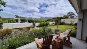 a patio with two chairs and a garden at 40 on Longmarket in Stanford