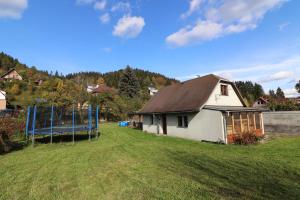 a house in a field with a basketball hoop at Chata pod Paluchem in Vsetín