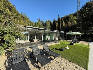 a group of chairs sitting in the yard of a house at Villa Teixugueiras 1 - Gerês in Vieira do Minho