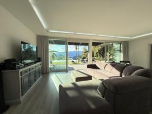 a living room with two couches and a television at Villa Teixugueiras 1 - Gerês in Vieira do Minho