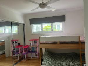 a bedroom with a bunk bed and stools at Relaxed Coastal Newport Getaway in Newport +2 photos