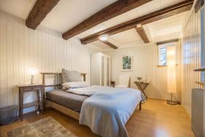 a bedroom with a bed with a blue blanket at Alte Polsterei in Nienstädt