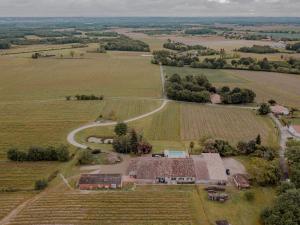 an aerial view of a farm with a building and a road at domaine de codeval in Fronton
