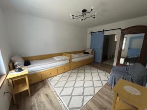 a room with a bed and a table and a room with at Kökény Kunyhó in Kisszékely