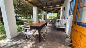 a wooden table and chairs on a patio at Lavender’s Blue in Stanford