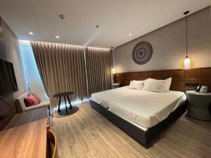 a bedroom with a bed and a table and a chair at Min Min Retreat in Phước Hậu