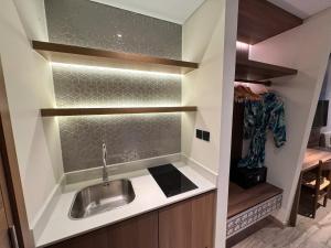 a kitchen with a stainless steel sink in a room at Min Min Retreat in Phước Hậu +17 photos