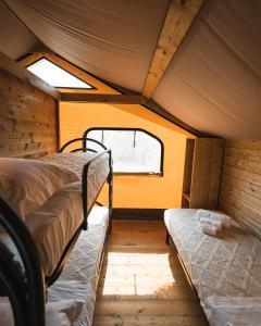 a bedroom with two beds in a tent at Glamping Poggio Nardini in Montelupo Fiorentino +27 photos
