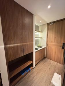 a kitchen with a large wooden door and a sink at Min Min Retreat in Phước Hậu