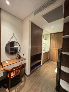 a room with a desk and a television on a wall at Min Min Retreat in Phước Hậu