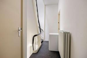 a hallway with a stairway in a room at Comfortable 1-Bedroom Flat in Central Rotterdam in Rotterdam