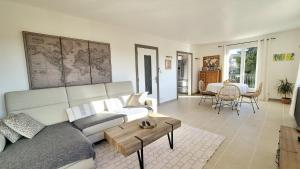 a living room with a couch and a table at La casemate in LʼIsle-sur-la-Sorgue
