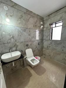 a bathroom with a toilet and a sink at Savitri villa inn in Mahabaleshwar