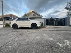 a white car parked in front of a house at SRE- Holiday Home in Prime Village, Mae Sot  +8 photos
