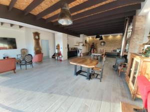 a large living room with a wooden table and chairs at domaine de codeval in Fronton