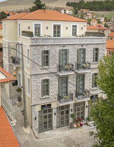 a large stone building with windows and balconies at Megaro Gioule in Siatista