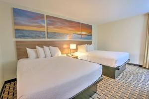 a hotel room with two beds and a painting on the wall at Hotel Carolina Double Room - 2 Queen Beds in Hilton Head Island