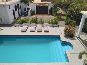 a swimming pool with two lounge chairs next to a house at Premium Villa in Ngaparou between Saly Somone in Ngaparou