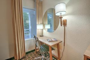 a room with a desk with a mirror and a chair at Hotel Carolina Double Room - 2 Queen Beds in Hilton Head Island