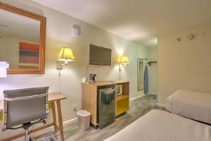 a room with a bed a desk and a tv at Hotel Carolina Double Room - 2 Queen Beds in Hilton Head Island +5 photos