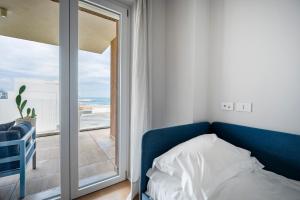 Postel nebo postele na pokoji v ubytování Palazzo Verdi - Seafront Luxe Retreat
