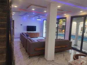 a living room with two couches and a tv at Premium Villa in Ngaparou between Saly Somone in Ngaparou