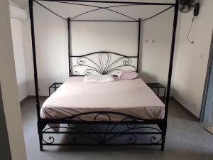 a black and white bed with two pillows on it at Premium Villa in Ngaparou between Saly Somone in Ngaparou +48 photos