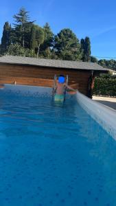 a man is in a swimming pool in the water at Dream's Rooms Salemi in Ulmi