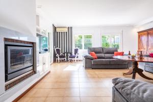 a living room with a couch and a fireplace at Mario in Vinaròs